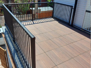 Balcony flooring made with porcelain deck tiles, wood imitation, and built by Urban Balcony.